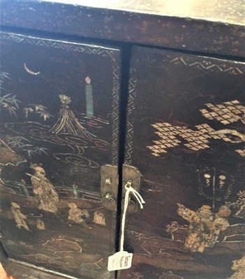 Lot 479 - A Chinese Kangxi Lac Burgaute Two-Door Cabinet, inlaid in mother-of-pearl with figures in...