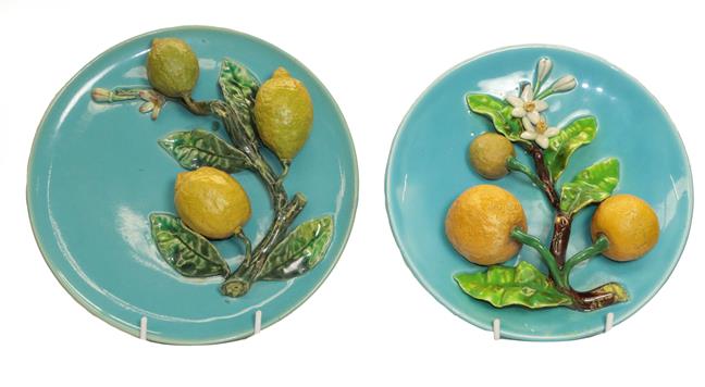 Lot 59 - A pair of 19th century Continental Majolica wall plaques applied with fruit, 25cm diameter