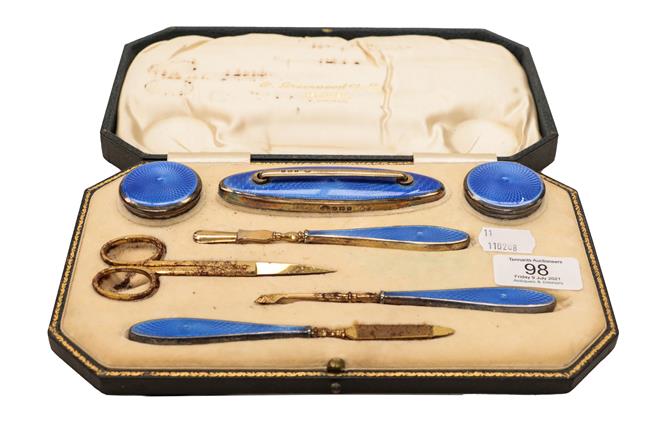 Lot 98 - A George V cased silver gilt enamelled manicure set by Adie Brothers, Birmingham, 1926, retailed by