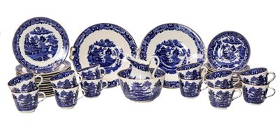 Lot 104 - A collection of Victorian blue and white Willow pattern teawares, twelve settings, gilt...