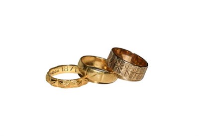 Lot 127 - Two 18 carat gold textured band rings, finger sizes K1/2 and L1/2; and a 9 carat gold textured band