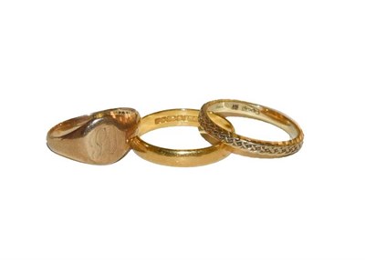 Lot 145 - A 22 carat gold band ring, finger size R, a 9 carat gold textured band ring, finger size Q, and...