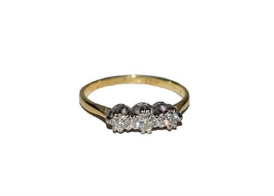 Lot 156 - An 18 carat gold diamond three stone ring, the graduated round brilliant cut diamonds in white claw