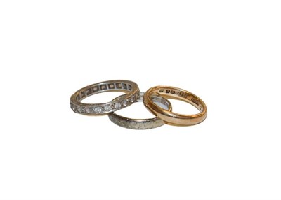 Lot 165 - Two 9 carat gold band rings, finger sizes L and N, and a white sapphire eternity ring, stamped...