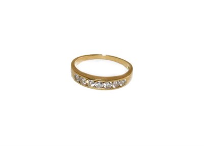 Lot 166 - A diamond seven stone ring, the round brilliant cut diamonds in a yellow channel setting, to a...