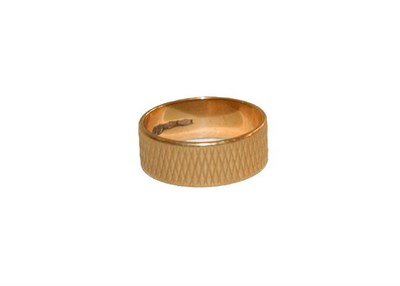 Lot 167 - A texture band ring, stamped '750', finger size O