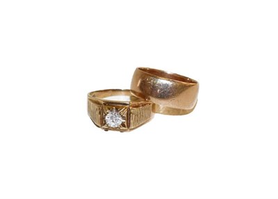 Lot 175 - A 9 carat gold band ring, finger size S1/2, and a 9 carat gold paste solitaire ring, finger...