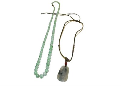 Lot 177 - A graduated jade bead necklace, length 73cm; and a jade type pendant on cord necklace