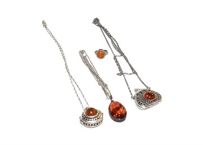 Lot 183 - A collection of amber type jewellery including pendants on chains, brooches, earrings,...
