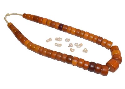 Lot 196 - A string of West African amber type beads, length 86cm (approximately), and a quantity of...