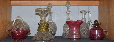 Lot 208 - A Waterford style glass mushroom lamp, three decanters, a cranberry glass oil lamp, and a dish (6)