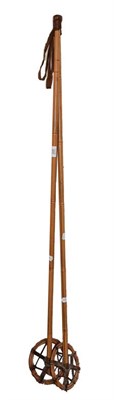 Lot 228 - Two walking canes, a pair of bamboo ski poles, and a four piece brass companion set (8)