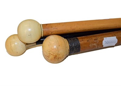 Lot 232 - An ivory mounted malacca walking cane, circa 1900, with ball handle and stamped white metal...