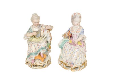 Lot 256 - Two 19th century Meissen figures, both seated, one feeding a dog seated on her lap, the other...