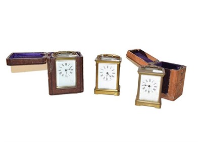Lot 277 - Three French brass carriage timepieces, two with fitted cases (one tray)