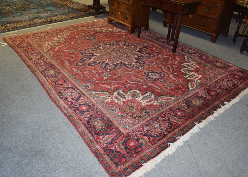 Lot 1001 - Ahar Heriz carpet, the blood red field with a central flower head medallion framed by...