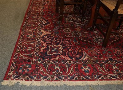 Lot 1007 - Bakhtitari carpet, the blood red field centered by a flower head medallion framed by spandrels...