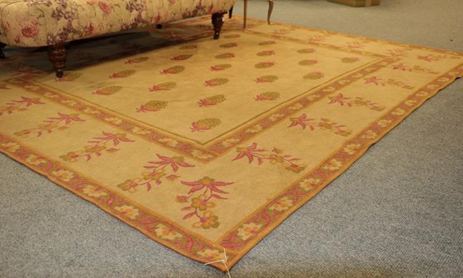 Lot 1008 - A machine made rug of Aubosson design, the pale camel ground of plants enclosed by borders of...