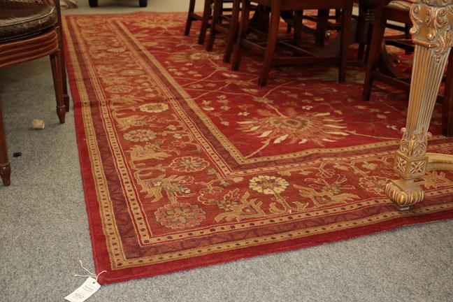 Lot 1012 - A machine made carpet of Zeigler design, the deep terracotta field with an all over design of large