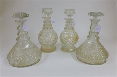 Lot 5 - A Pair of Triple Ring Necked Ship's Decanters, 19th century, with fluted stoppers over oval cut...