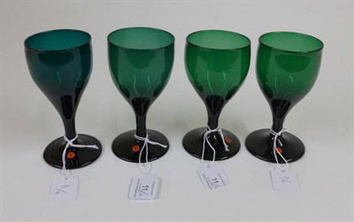 Lot 11 - A Matched Set of Four Green Wine Glasses, circa 1800, the drawn funnel bowls on plain stems and...