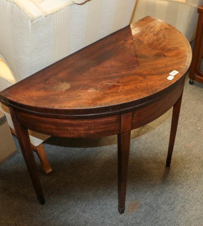 Lot 1092 - A George III mahogany demi lune foldover tea table, 94cm by 46cm by 74cm