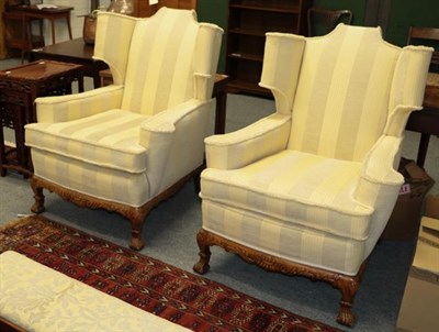 Lot 1094 - A Georgian style three-piece suite comprising a three seater sofa and pair of wing back...