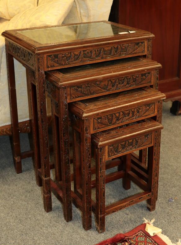 Lot 1095 - A 20th century Chinese heavily carved nest of four occasional tables, 50cm by 36cm by 65cm