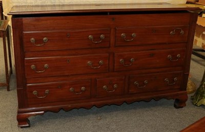 Lot 1097 - A George III mahogany Lancashire chest, with fluted corner columns and raised on ogee bracket feet