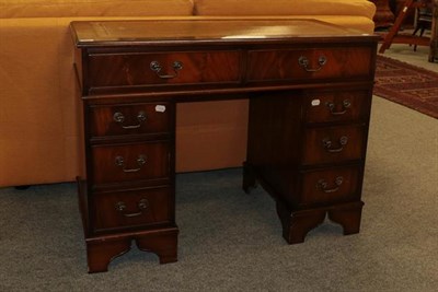 Lot 1100 - A reproduction mahogany veneered leather inset twin pedestal desk, 107cm by 54cm by 80cm