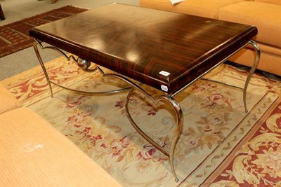 Lot 1101 - A modern coffee table with simulated rosewood top on a chrome base, 117cm by 71cm by 53cm purchased