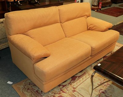 Lot 1102 - A pair of modern French designer sofas in orange upholstery, by Ligne Roset