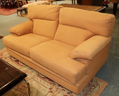 Lot 1102 - A pair of modern French designer sofas in orange upholstery, by Ligne Roset