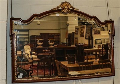 Lot 1110 - A mahogany and parcel gilt framed arch top over mantel mirror, 107cm by 76cm