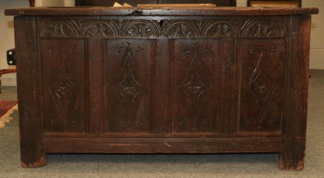 Lot 1120 - An 18th century panelled oak coffer, with hinged lid and carved frieze, 128cm by 58cm by 70cm