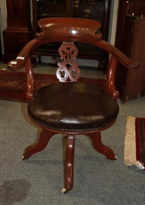 Lot 1128 - A late Victorian revolving office chair with leatherette seat and closed nail decoration