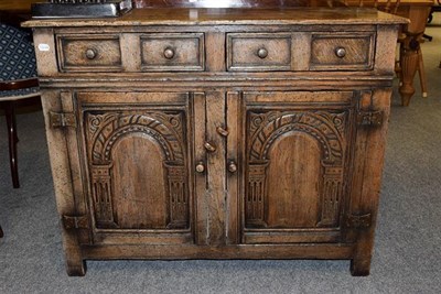 Lot 1133 - A panelled oak two drawer side cabinet in the Titchmarsh & Goodwin style, 107cm by 43cm by 84cm