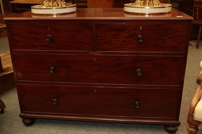 Lot 1145 - A Victorian mahogany three height chest of drawers with turned handles and raised on squat bun...