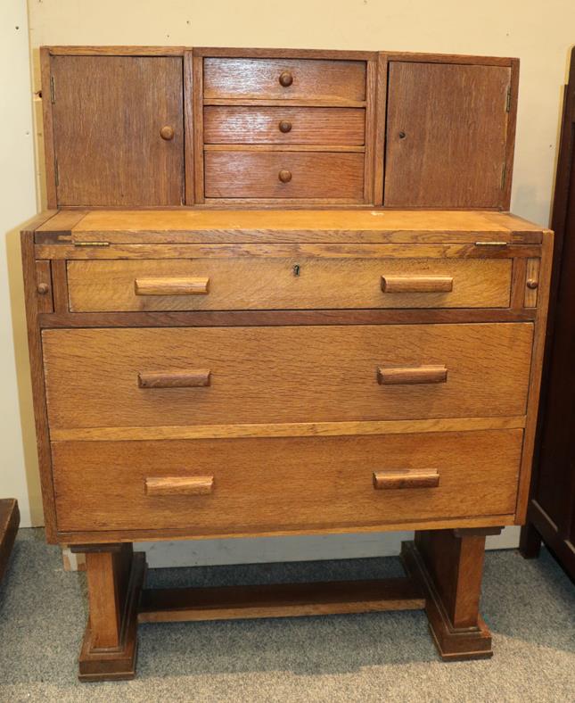 Lot 1146 - A circa 1930s oak writing bureau, together with an early 20th century oak chest of drawers with...