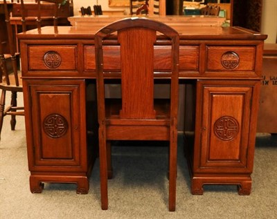 Lot 1151 - A Chinese twin pedestal desk, 20th century, 117cm by 59cm by 83cm with a single chair (2)