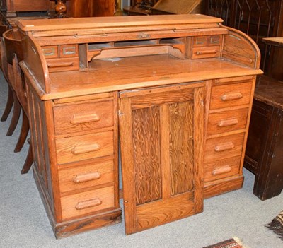 Lot 1182 - An early 20th century oak roll top desk, the escutcheon stamped LEBUS DESK, 122cm by 68cm by 102cm