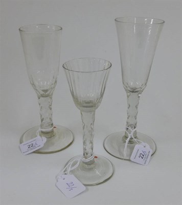 Lot 22 - A Wine Glass, circa 1770, the vertically fluted rounded funnel bowl on a faceted stem and...