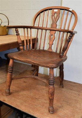 Lot 1188 - A 19th century elm Windsor chair, 86cm high, together with an occasional table with a wrought metal