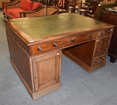 Lot 1214 - A small leather inset oak partners desk, 137cm by 100cm by 76cm