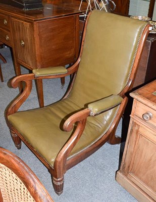 Lot 1215 - A 19th century mahogany and studded green leather low chair, with padded scroll arms and reeded...
