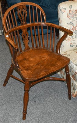 Lot 1222 - A 19th century yew and elm Windsor armchair with dished seat and crinoline stretcher