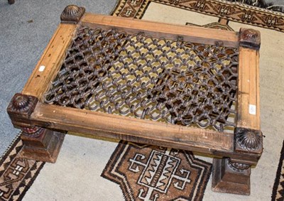 Lot 1251 - A Middle Eastern metal-mounted part painted low table with mesh top, 80cm by 57cm by 30cm