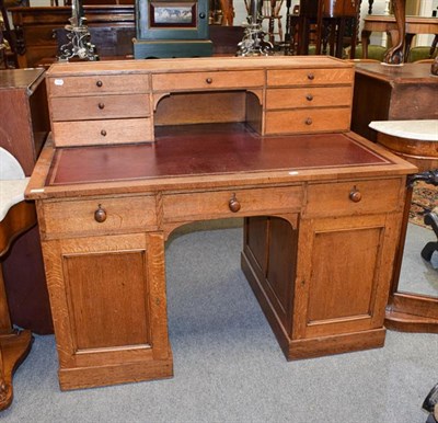 Lot 1261 - An early 20th century leather inset oak desk with superstructure, 127cm by 79cm by 105cm