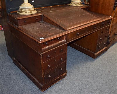 Lot 1283 - A leather top desk with bureau top, 152cm by 80cm by 84cm