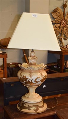 Lot 1284 - A pair of parcel gilt cream table lamps of urn form (2)
